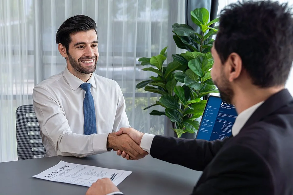 happy-job-candidate-shakes-hands-with-the-recruiter-hiring-manager-before-an-interview